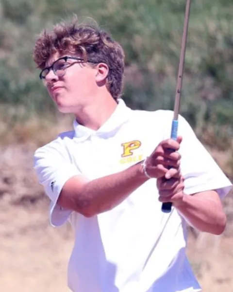 College golfer mid-swing