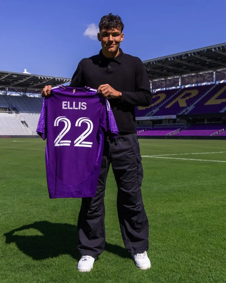 Justin Ellis holding his Orlando City SC jersey